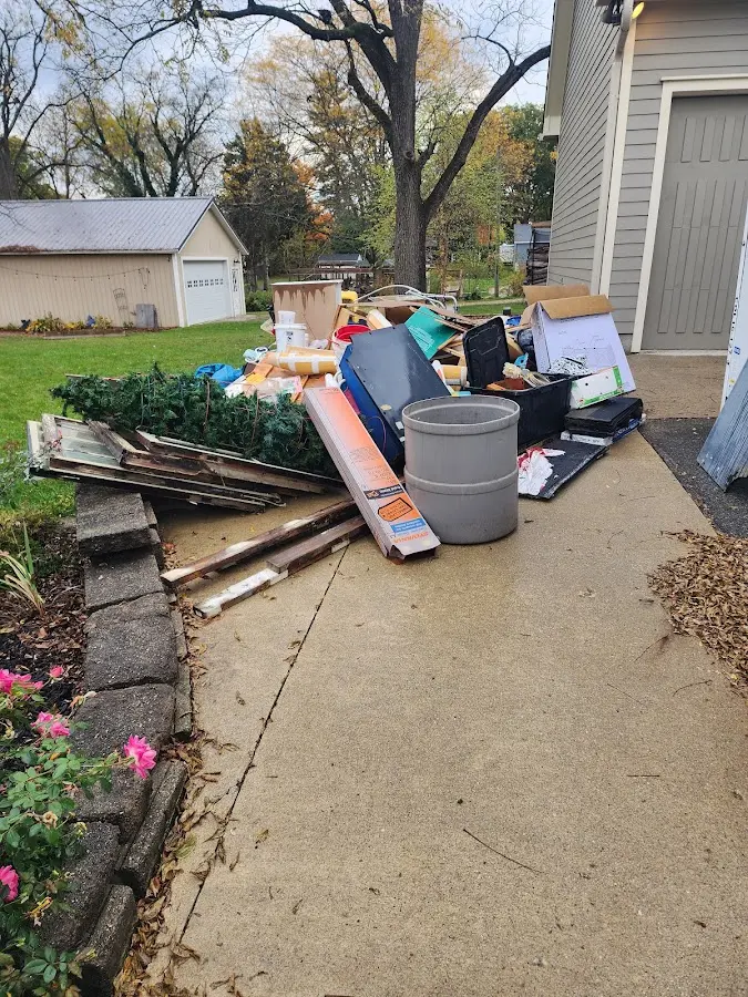 Dumpster being loaded with debris for 12 Yard Dumpster Rental in Ione